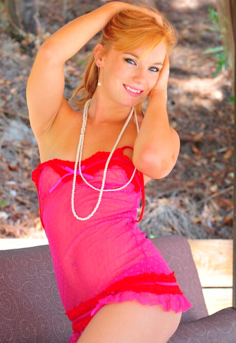 Sylphlike american red-haired young Dani Jensen in sexy undies posing outdoor